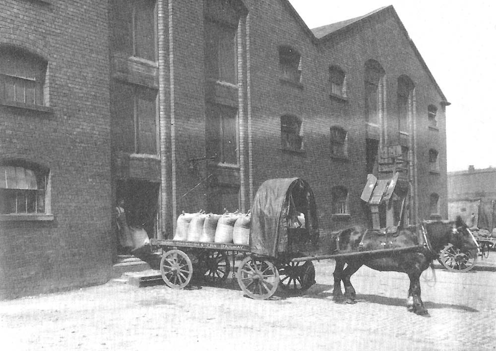 Great Western Railway single horse flat trolley being loaded with sacks for distribution at the end of the Inwards Shed and Warehouse