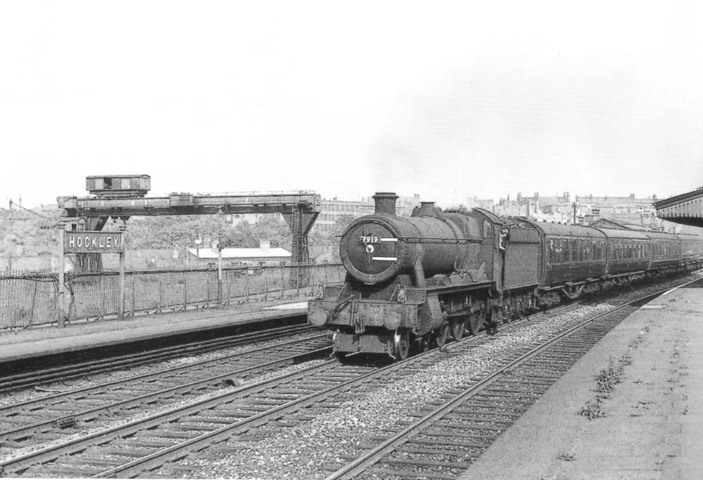 BR built 4-6-0 Modified Hall No 7919 'Runter Hall' passes through Hockley Station on the down main line