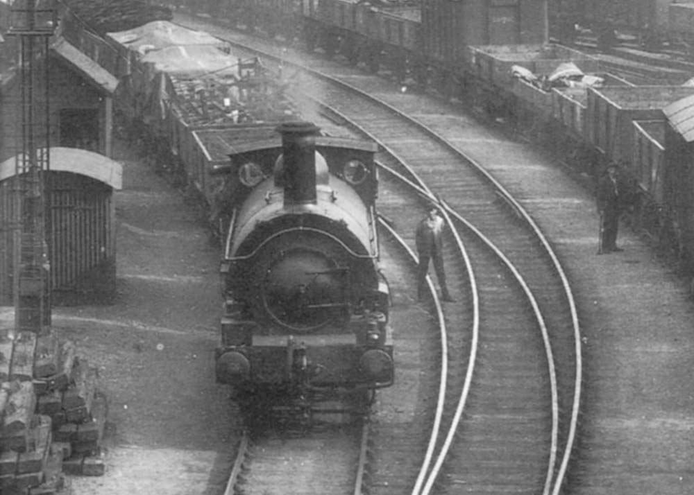 Close up showing the unidentified Great Western Railway's 0-6-0ST marshalling trains in the yard