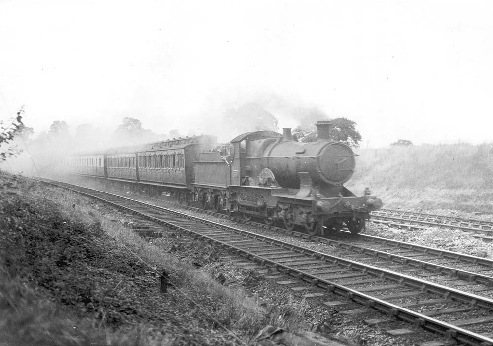 GWR 4-4-0 Bulldog class No 3372 'Sir N Kingscote' on an up excursion train with the  two clerestory coaches behind the tender