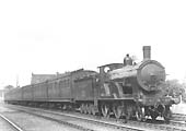 Ex-London South Western Railway 4-4-0 class T9 No 288 is seen at the head of an up express made up of Southern rolling stock in September 1926