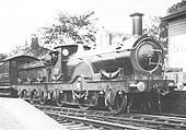 GWR Queen class  2-2-2 No 1128 Duke of York is seen standing at Knowle & Dorridge with an up local service