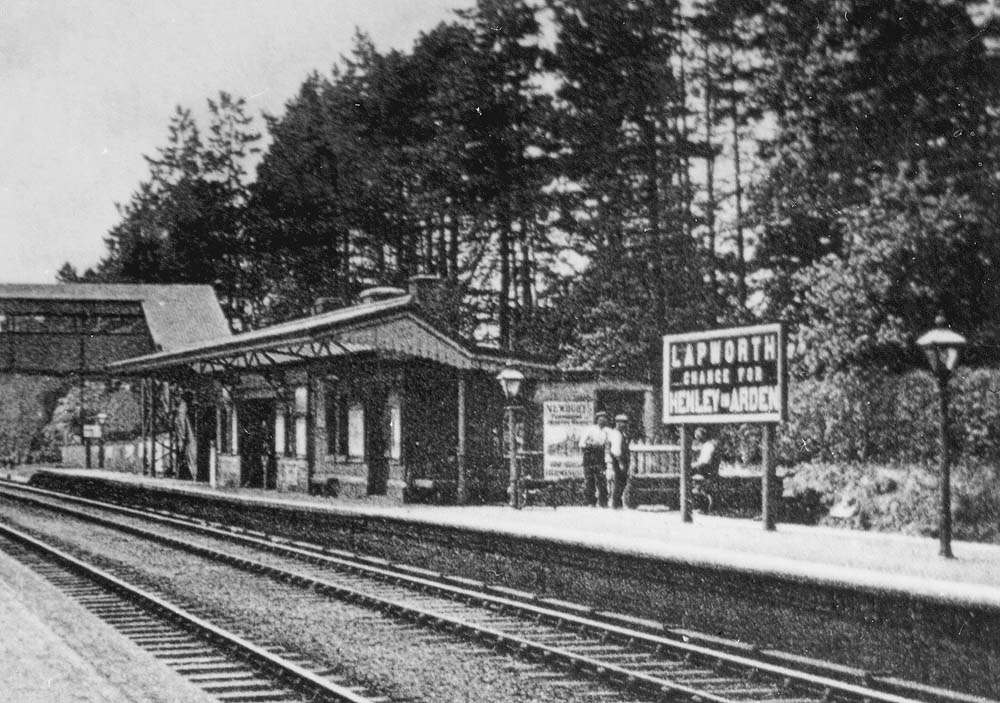 Close up showing passenger footbridge and the down platform structure which appears to be an amalgam of two buildings