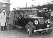 Photograph of Lapworth station's taxi driven by Edward Giles and Lapworth' station master Mr Ted Giles and other staff and members of the public
