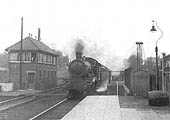 An unidentified GWR 4-6-0 Saint class locomotive is seen passing Lapworth signal box on the 11:15am Wolverhampton to Weymouth express circa 1935