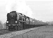 British Railways built Battle of Britain Class No 34088 '213 Squadron' heads through Lapworth on a football special