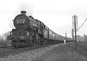 An unidentified ex-GWR King Class locomotive is seen on an up express service near Lapworth on 14th April 1962