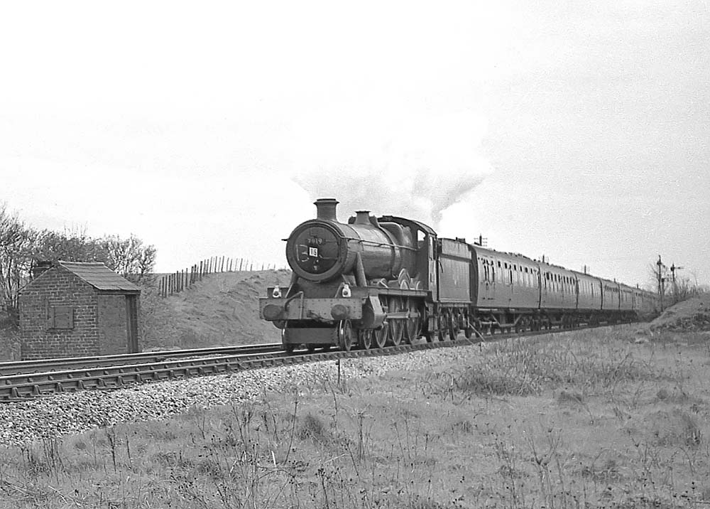 British Railways built 4-6-0 No 7919 'Runter Hall' is seen on a football special near Lapworth on 27th April 1963