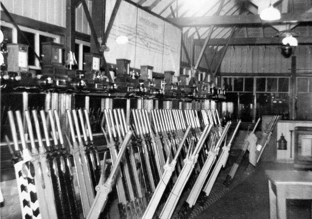 A nighttime interior view of Lapworth Signal Box showing the lever frame and instrument below the display panel circa 1956
