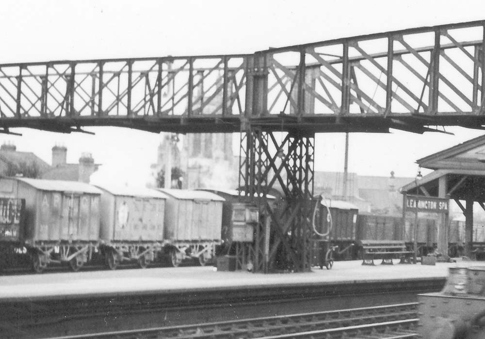Close up showing both covered and open wagons passing through the station on the goods loop line