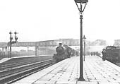 An unidentified GWR 4-6-0 Saint Class locomotive stands at the down platform with an express for Snow Hill