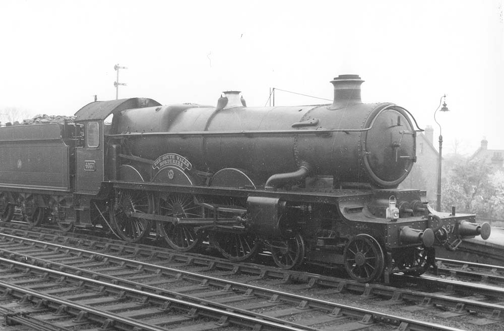 GWR 4-6-0 No 4037 'The South Wales Borderers' is held by signals on the up middle road with an up through freight