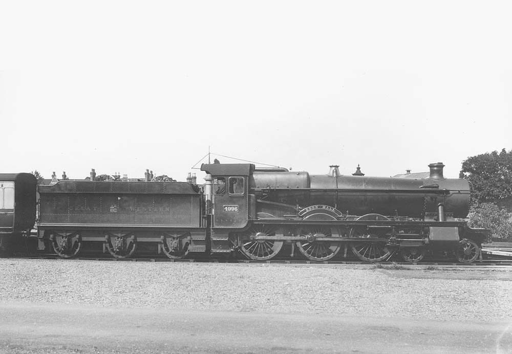 GWR 4-6-0 No 4996 'Eden Hall', at the head of an up express service, is seen waiting for the right of way