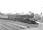GWR 4-6-0 No 6019 'King Henry V' pauses at the head of an up express with a Siphon behind the tender
