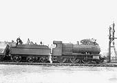 GWR 2-6-0 'Mogul' No 6329 stands at the head of an up goods train taking on water in the up platform