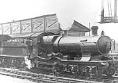 GWR 33xx Bulldog class 4-4-0 No 3338 'Swift' stands on the up through line with empty coaching stock