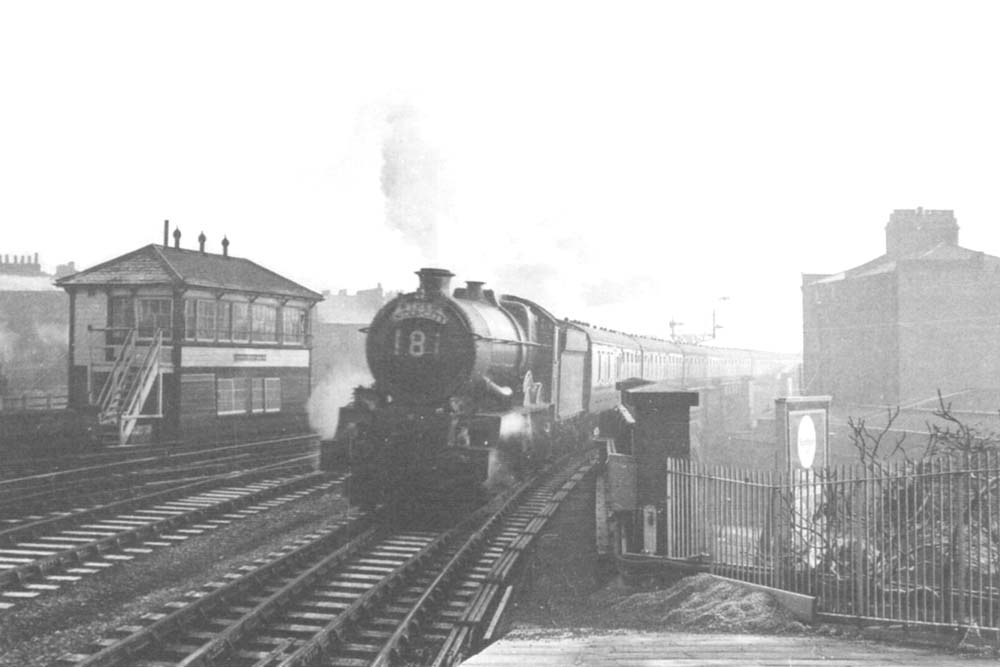 An unidentified ex-GWR King Class locomotive speeds through the station on the non-stop down Inter-City express in 1958