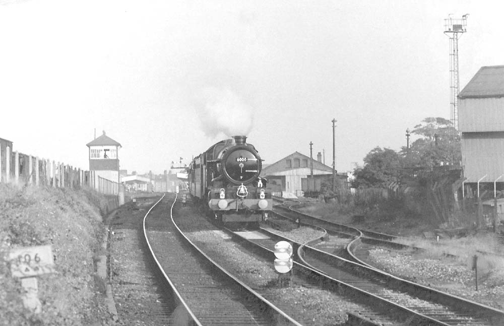 Ex-GWR 60xx Class 4-6-0 No 6000 'King George V' storms past Ford's foundry on a down special in 1971