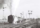 British Railways Standard Class 9F 2-10-0 No 92203 is seen piloting an unknown diesel on a down service to Snow Hill