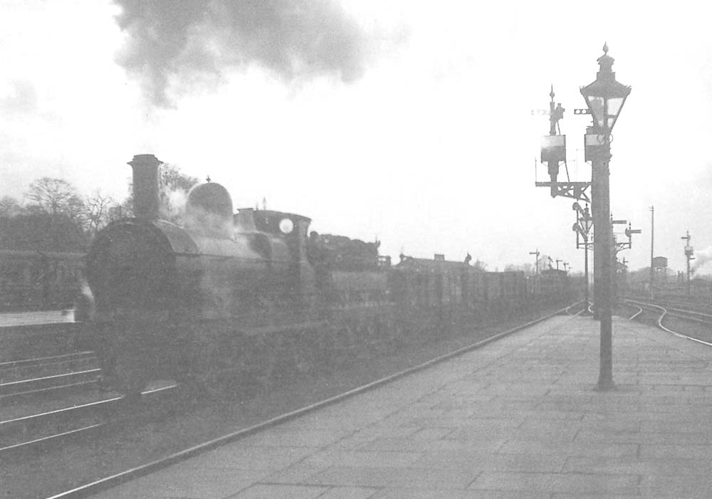 An unidentified 'Standard Goods' runs through Leamington Spa station with an up coal train probably from ex-Bordesley