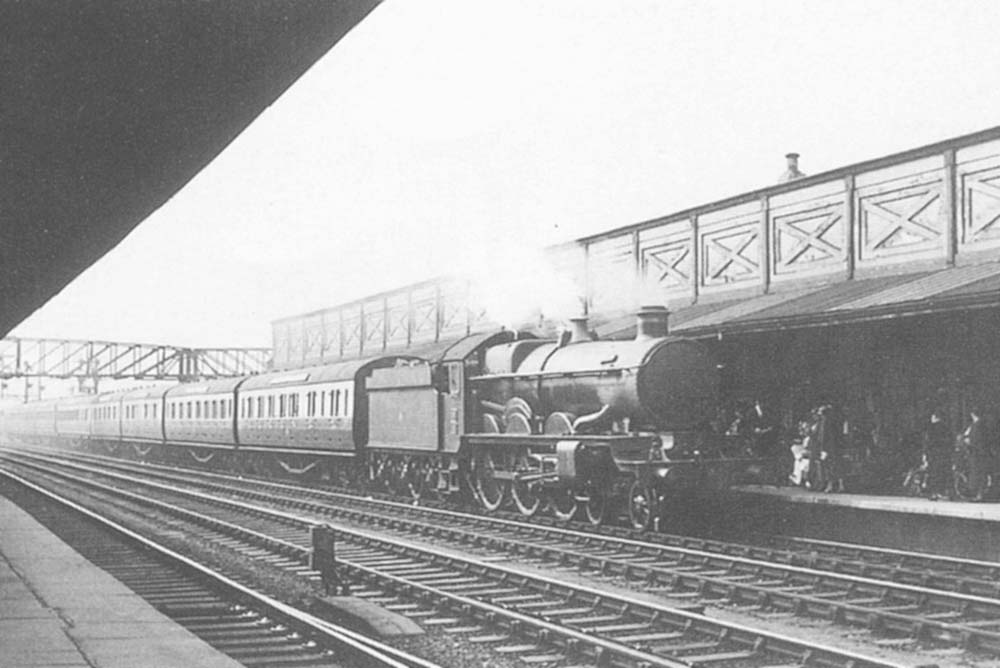 GWR 4-6-0 Castle class No 100 'A1 Lloyds' is seen arriving at the up platform with an express for London