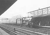 GWR 4-6-0 Castle class No 100 'A1 Lloyds' is seen arriving at the up platform with an express for London
