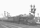 An unidenitified GWR 4-6-0 King class locomotive at the head of the 9.05 Birkenhead to Paddington express train runs into the up platform