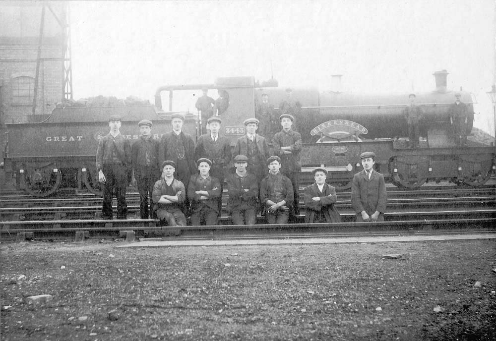 GWR Bulldog Class 4-4-0 No 3443 'Birkenhead' is posed in front of the coaling stage with shed staff