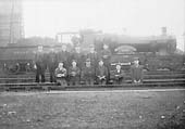 GWR 33xx Class 4-4-0 No 3443 'Birkenhead' is posed in front of the coaling stage with shed staff