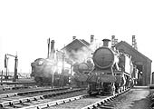 GWR 28xx Class 2-8-0 No 2838 plus two other locomotives stand outside the shed on 12th February 1939