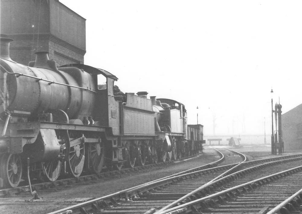 Close up showing locomotives and loco coal wagons standing on the siding adjacent to the road leading to the turntable