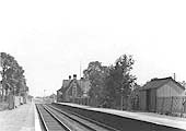 View of Long Marston station showing the main brick-built structure on the right and the timber passenger waiting room on the left