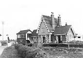 Broadside view of the original 1859 Milcote station and short platform with the signal box and level crossing on the left