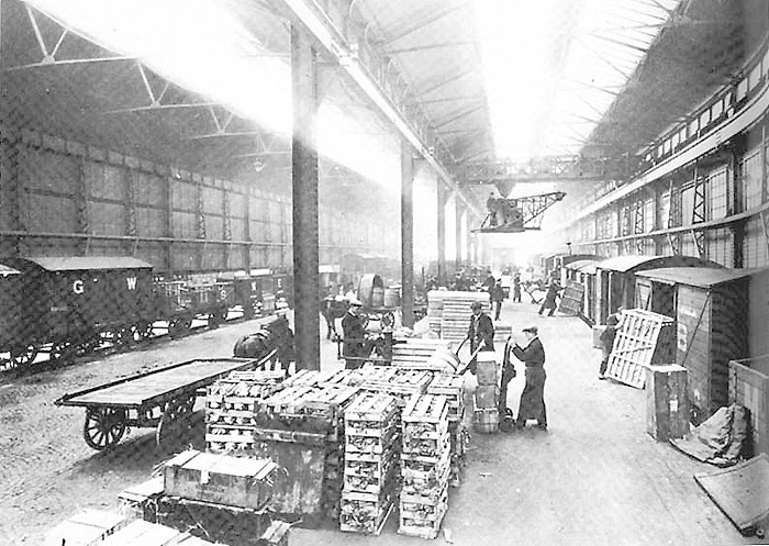 Internal view of Moor Street stations' upper Goods Shed handling vegetable traffic with an overhead gantry crane in operation
