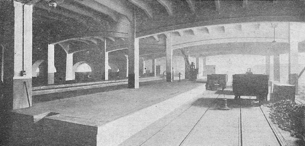 An internal view of lower level shed 'B' under construction showing the two unloading platforms and one of the two fixed cranes on the left