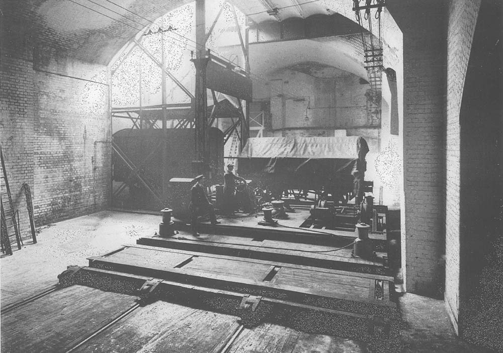 Demonstration of a covered wagon being moved by a 30 ton traverser whilst a van is seen standing in the cage of one of the two hoists located in shed 'B'