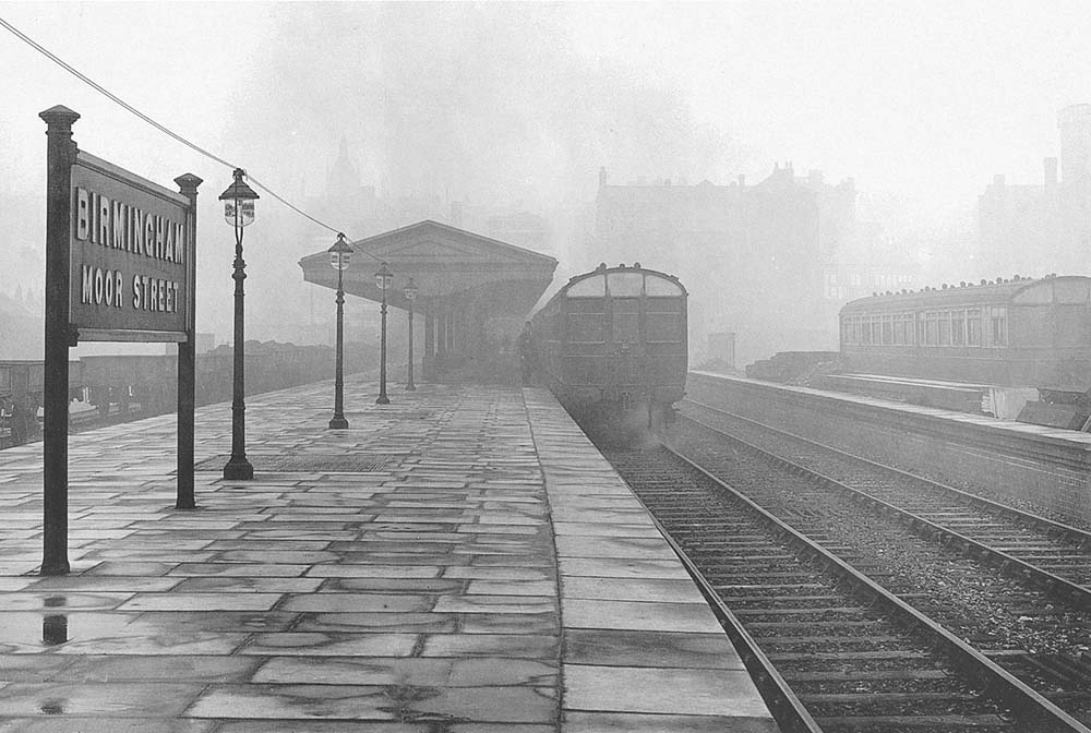 On a wet June day in 1911 a Steam Railcar waits at the island platform at Moor Street Station