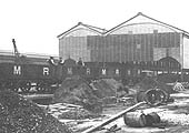 Close-up showing a train of Midland Railway open wagons delivering materials for the contractors