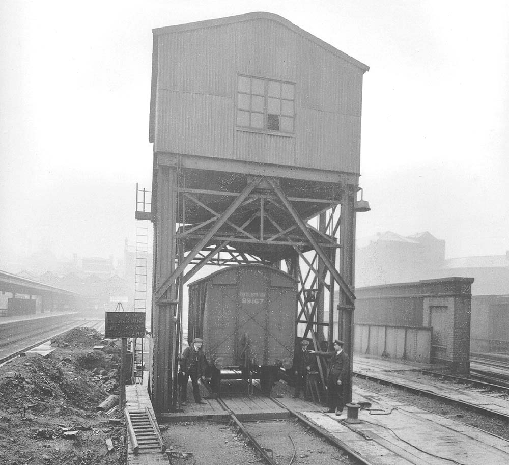 An official posed photograph showing a ten ton, wooden Mink A covered wagon on the twenty ton electric wagon hoist