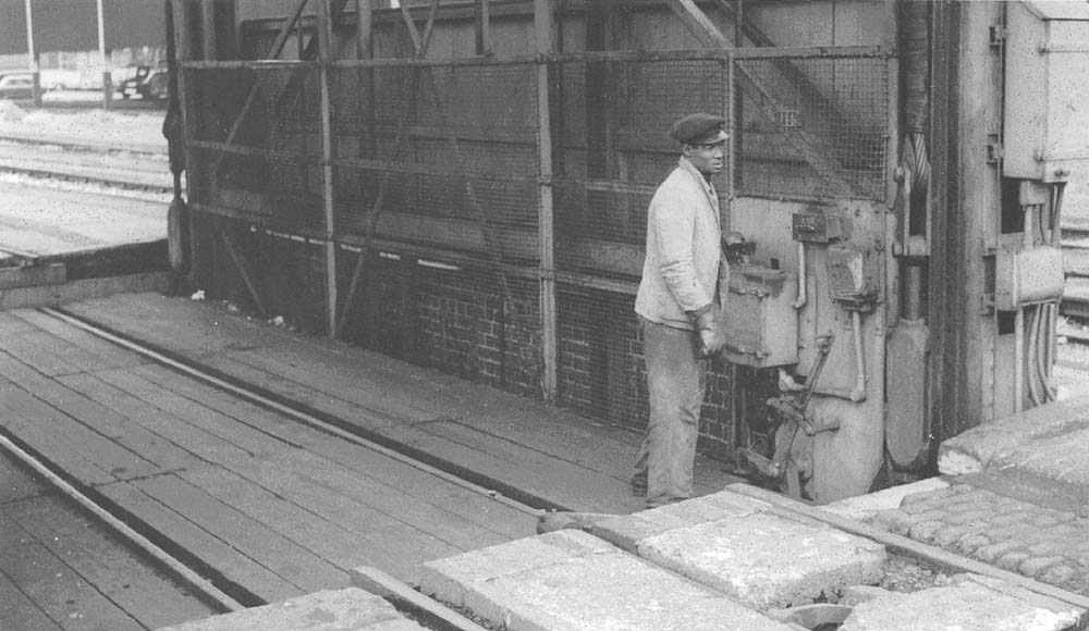 Mr A. Facey, the Shunter, at the controls of the electrically powered 30 ton wagon hoist above Shed B warehouse