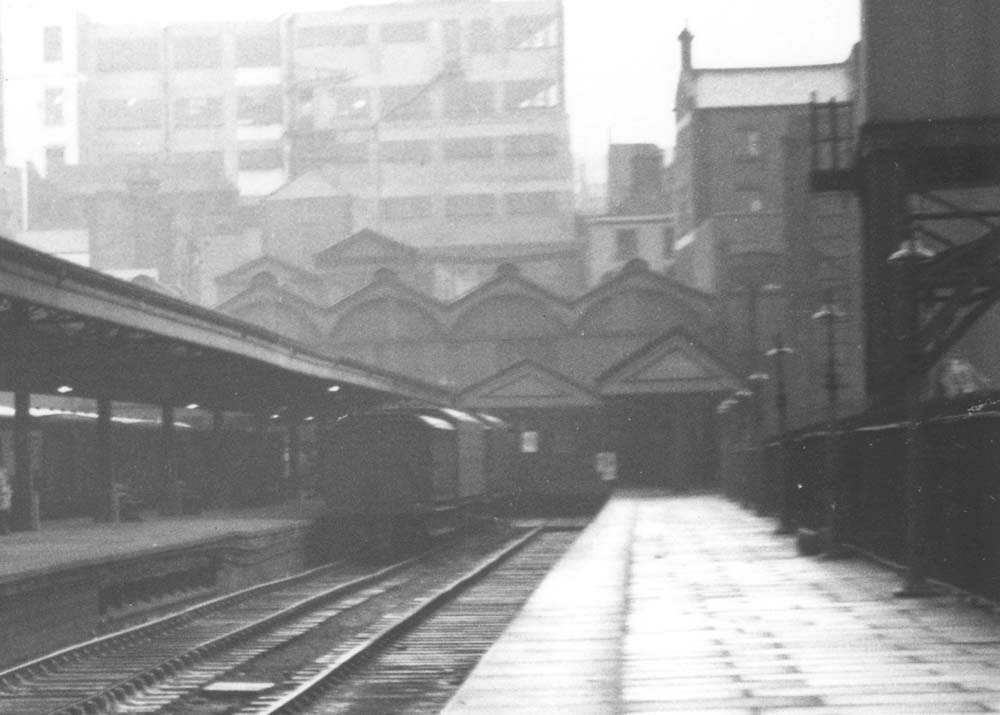 Close up view of the terminus end of the platform showing three miscellaneous vehicles standing next to the traverser