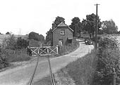 View of Shipston Road Level Crossing being closed by the guard as seen from the rear of his brake van with the gate keeper's house on the right