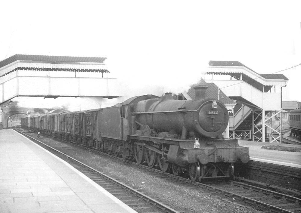 Ex-GWR 4-6-0 49xx class No 6922 	'Burton Hall' passes through Moreton-in-Marsh with the 'Up Perishables'