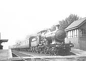 An unidentified GWR 4-4-0 Badminton class locomotive passes Olton's now redundant signal box