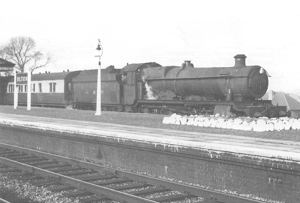 Ex-GWR 4-6-0 No 6953 'Leighton Hall', modified to burn oil, passes through the station on the up main line in 1948