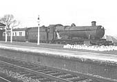 Ex-GWR 4-6-0 No 6953 'Leighton Hall', modified to burn oil, passes through the station on the up main line