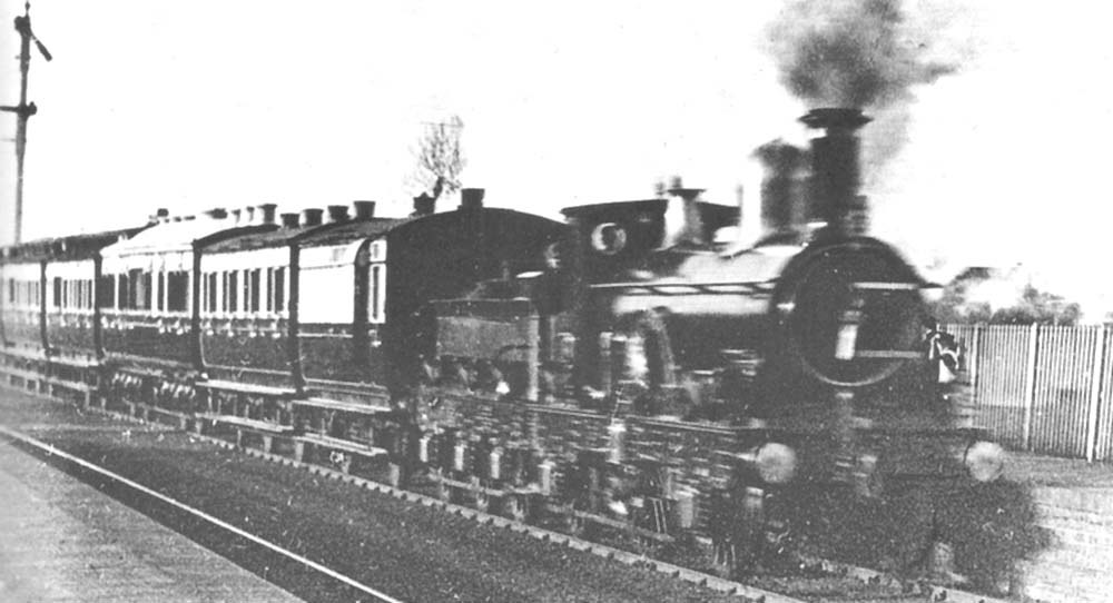 Great Western Railway 2-2-2 No 55 'Queen' hauls the Royal Train through Olton station in March 1887