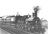 Great Western Railway 2-2-2 No 55 'Queen' hauls the Royal Train through Olton station in March 1887