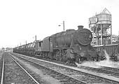 Ex-LMS 8F 2-8-0 No 48312 is seen at the head of a Type 7 working at Queens Head Sidings on 26th September 1964