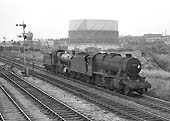 Ex-LMS 8F 2-8-0 No 48436 pilots ex-GWR 78xx Class 4-6-0 No 7803 'Barcote Manor' past Queens Head sidings on 22nd July 1964